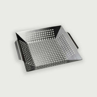 Perforated stainless steel cooking basket, ideal for grilling vegetables or side dishes on a kamado barbecue.